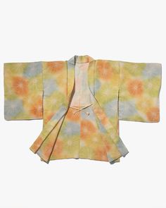 Made to be worn open over long kimono, Haori features colorful patterns and traditional methods of decorative craftsmanship. The garment has a simple design with square, draping sleeves, but has interesting details like small decorative ties that act as accent pieces on the front. Pair our vintage Haori with a simple tee and jeans (or maxi skirt) for a unique casual look. Worn with a collared button-up shirt and skirt or pants, the Haori jacket acts as a loose-fitting blazer. Versatile, comforta Multicolor Silk Kimono With Kimono Sleeves, Multicolor Outerwear With Kimono Sleeves, Vintage Multicolor Outerwear With Kimono Sleeves, Vintage Multicolor Spring Kimono, Multicolor Cotton Kimono With Kimono Sleeves, Traditional Multicolor Silk Kimono, Haori Jacket, Kimono Style Jacket, Shirt And Skirt