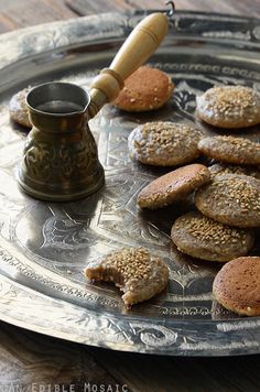 some cookies are sitting on a silver plate