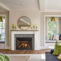 a living room filled with furniture and a fire place in the middle of a room