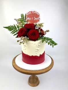 a red and white cake with flowers on top