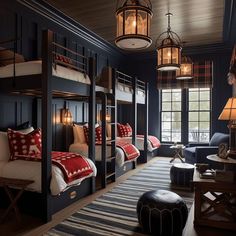 a bedroom with bunk beds and lamps in it's dark blue walls, along with other furniture