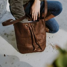 First, design a women’s leather bucket bag that doesn’t look like a bucket. Next, offer it in a rich brown full grain leather. Then, provide a comfortable, adjustable leather strap so it can be worn crossbody or over the shoulder. And finally, thread it with a smooth leather drawstring to close it all up. The result? The Madison brown leather bucket bag. The Madison brown leather bucket bag is fully lined with neutral, striped fabric and includes an interior zipper pocket for things you want to Keep Private, Madison Brown, Sling Bag Women, Street Style Bags, Functional Style, Perfect Handbag, Bag Dark, The Madison, Leather Satchel Bag