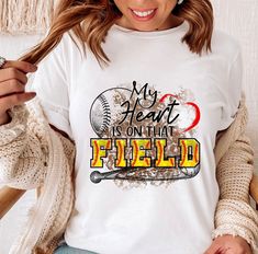 a woman wearing a t - shirt that says, my heart is on that field