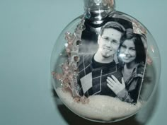 a glass ornament with an image of a man and woman in it