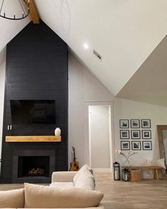 a living room with a fireplace and large clock on the wall