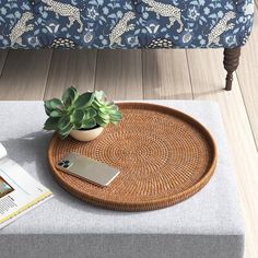 a tray with a plant on top of it next to a magazine and a cell phone