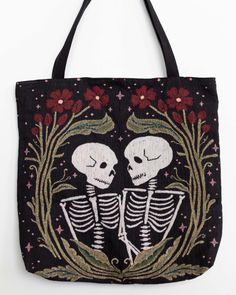 a black tote bag with two skeletons on it