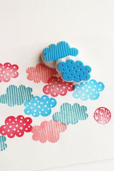 a pair of blue and red buttons sitting on top of a piece of paper