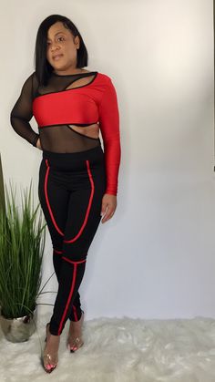 Black and red long sleeve sheer bodysuit with snap closure and matching black high waist pants with elastic waistband. Edgy Long Sleeve Bodysuit For Night Out, Red Stretch Long Sleeve Unitard, Trendy Red Long Sleeve Bodysuit, Red Long Sleeve Stretch Unitard, Red Stretch Bodysuit For Night Out, Red Long Sleeve Bodysuit For Night Out, Stretch Unitard For Night Out, Red Stretch Unitard For Party, Red Stretch Bottoms For Date Night