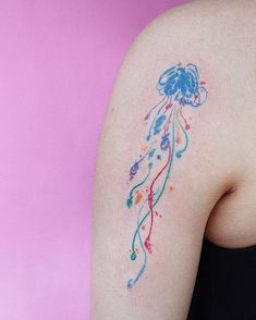 a woman's arm with a tattoo on it that looks like a jellyfish