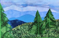 an embroidered landscape with trees and mountains in the background