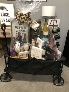 a black cart filled with wine bottles and other items