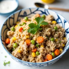 a bowl filled with rice, peas and carrots