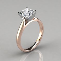 an engagement ring with a single diamond in the center, on a gray background photo