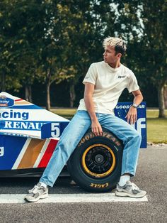 a man sitting on top of a racing car