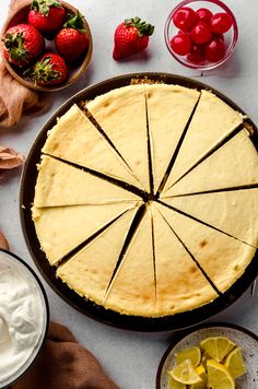 the pie is ready to be cut into slices and served with whipped cream, strawberries and lemons