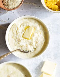 two bowls filled with oatmeal and butter on top of a white table