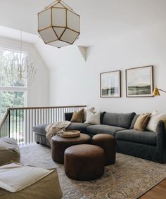 a living room filled with furniture next to a large window and a chandelier