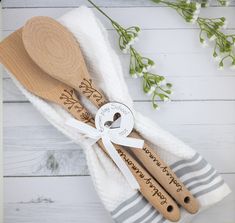 two wooden spoons on top of a white towel