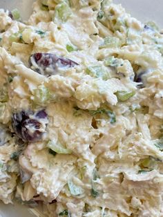 a white bowl filled with chicken salad on top of a table