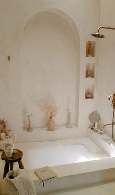 a bathroom with a large tub and shelves on the wall