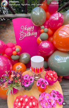 a table topped with lots of balloons and flowers