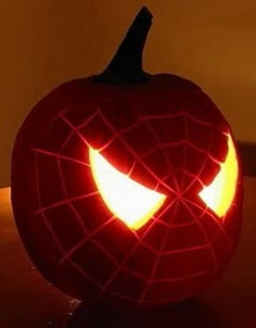 a spiderman pumpkin with its eyes glowing