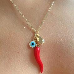 ️🌶️🌶️ ITALIAN SICILY CORNICELLO NECKLACE 🌶️🌶️🌶️ This Italian cornicello or red cacho necklace is known in Italian culture for being an amulet with protective powers against the evil eye and other negative energies, Handmade in 14k goldplated chain, Hypoallergenic for greater use and durability. THIS WILL BE THE AMULET YOU WILL ALWAYS WANT TO WEAR 🌶️🧿 SURPRISE YOUR SPECIAL PERSON WITH THIS UNIQUE ACCESSORY THEY WILL LOVE. ❤️🎁 🌶️ Characteristics: Material: Authentic red chub   Italian Cor Red Dangle Charm Necklaces, Red Handmade Dangle Charm Necklaces, Handmade Red Dangle Charm Necklaces, Red Pendant Jewelry With Charms, Red Charm Necklaces For Good Luck, Red Good Luck Charm Necklaces, Red Dangle Charm Necklaces With Lobster Clasp, Red Charm Necklace With Lobster Clasp, Unique Red Jewelry With Charms