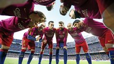 a group of men standing on top of a soccer field