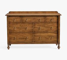 a wooden dresser with many drawers and knobs on the bottom drawer, against a white background