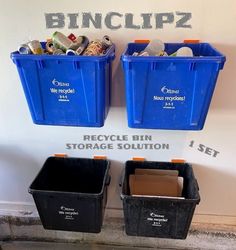 two blue bins are next to each other with recycling labels on the wall behind them