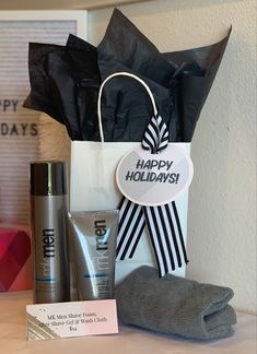 a gift bag with the words happy holidays on it next to some personal care products