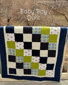 a baby boy quilt is hanging on a wooden rail with the words, baby boy quilt