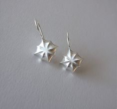 These beautiful earrings are inspired by the sparkling stars in the night sky. They are impressive and are great to wear as wedding jewelry or for other special occasions. They are made of 14k gold, and you can choose which color gold you want them to be made of- yellow or white gold. I plate the white gold with rhodium, as is common in white gold jewelry. I add 2 silicone stoppers for the earrings, that you can slip on the post after you wear the earrings so they won't fall off the ears. Each earring is 1.17 inches ( 3 cm ) long including the ear hoops, and the diameter of the star is 0.66 inches ( 1.7 cm ). Please note that the picture of the earrings on the model includes gemstones, but the item you are paying for does not include the gemstones! If you want to buy the earrings with the Elegant Silver Earrings With Star Charm, Elegant Star-shaped Jewelry With Ear Wire, White Sterling Silver Earrings With Star Charm, Elegant White Gold Earrings With Star Charm, Sterling Silver Star Earrings For Wedding, Elegant Star Charm Earrings For Anniversary, Elegant Starburst Earrings For Anniversary, Wedding Star-shaped Sterling Silver Earrings, White Gold Star Earrings For Formal Occasions