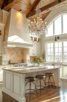 a large kitchen with an island and chandelier hanging from it's ceiling