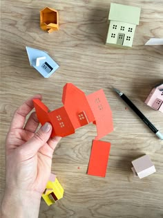 someone is making some paper houses out of construction materials