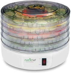 the food dehydrator is full of fresh fruits and vegetables