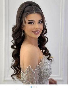 an image of a woman with long hair wearing a wedding dress and smiling at the camera