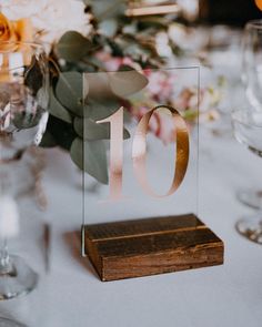 the table number is placed on top of a wooden block