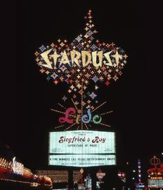 the marquee for stardust is lit up at night with lights and decorations