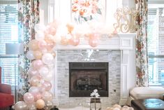 a living room filled with furniture and balloons hanging from the ceiling over a fire place