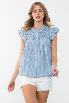 Smocked Blouse by THML THML is our favorite designer for tops for a reason! This striped, smocked blouse adds a touch of femininity while still being casual. The soft blues are perfect for spring and summer and looks great paired with crisp, white denim. Features a ruffled sleeve and button front with smocked detail at chest/bust. 100% Cotton XS fits Sizes 0-2Small fits Sizes 4-6Medium fits Sizes 8-10Large fits Sizes 12-14X Large fits Sizes 14-16 Smocked Blouse, Blue Striped Blouse, Smock Blouse, Denim Sweater, Linens And Lace, Blazer With Jeans, Flutter Sleeve Top, For A Reason, Striped Blouse