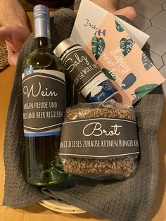 a bottle of wine and some nuts in a basket