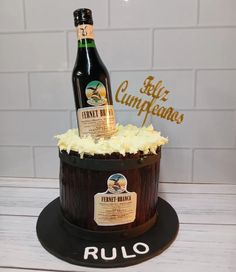 a bottle of beer sitting on top of a cake