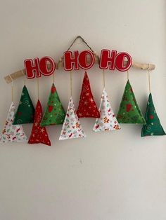 christmas decorations hanging on a wall with the word ho hoo in red and green