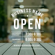 a wooden table with a business name open sign on it