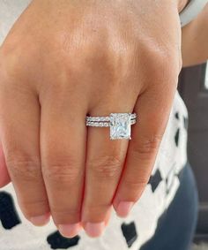 a woman's hand with a diamond ring on it