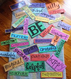 colorful bulletin board with words and phrases on it sitting on a wooden floor next to a gray towel