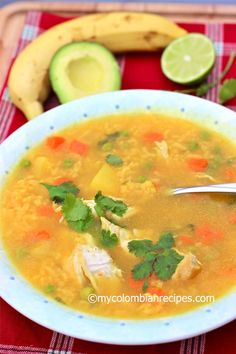 a bowl of soup with chicken, carrots and cilantro