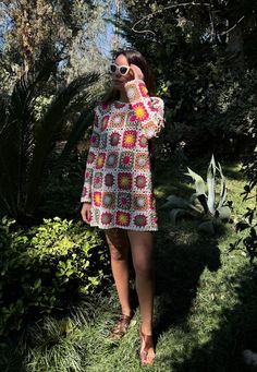 a woman taking a selfie with her cell phone while standing in front of some trees